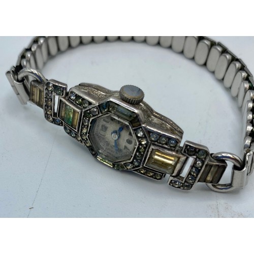 294 - An unmarked white metal Art Deco Style cocktail watch, set with paste stones, and a paste set bracel... 