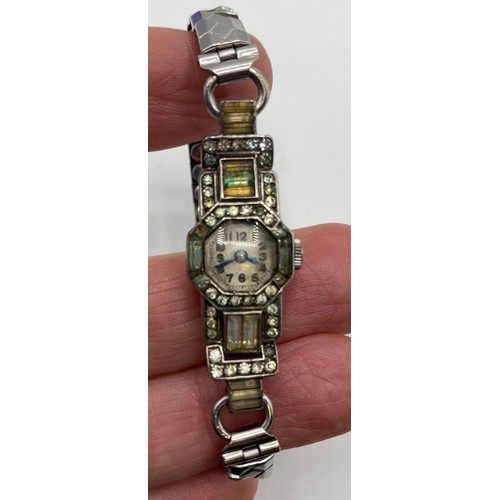 294 - An unmarked white metal Art Deco Style cocktail watch, set with paste stones, and a paste set bracel... 