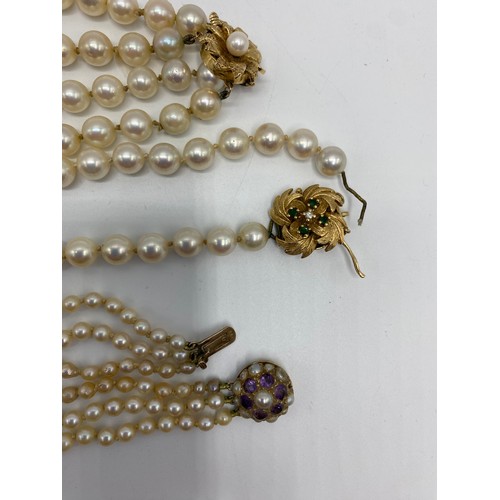 306 - Six pearl necklaces, to include a graduated three row with 9ct gold circular pearl and purple six st... 