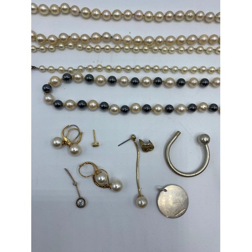 331 - Three strings of pearl necklaces, one stamped sterling silver to circular clasp with central pearl m... 