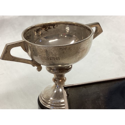 348 - Two  items of hallmarked silver, to include three  old trophy cups and a white metal cigarette box.