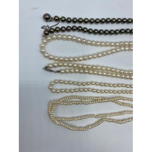 304 - A uniform strand of cultured pearls on a 9ct gold clasp, and another strand of cultured pearls on a ... 