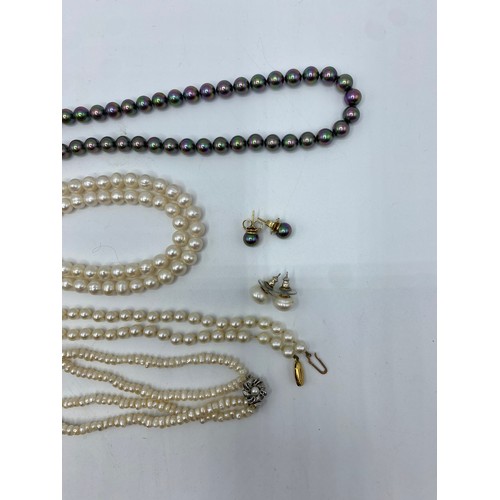 304 - A uniform strand of cultured pearls on a 9ct gold clasp, and another strand of cultured pearls on a ... 