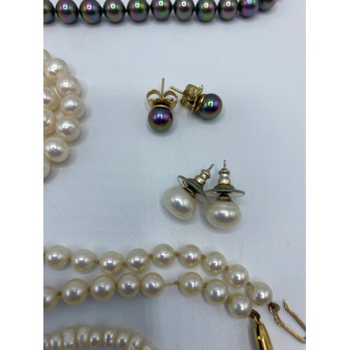 304 - A uniform strand of cultured pearls on a 9ct gold clasp, and another strand of cultured pearls on a ... 