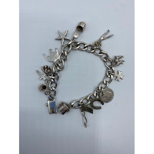 297 - A collection of silver jewellery to include charm bracelet and a white metal identity bracelet, 63g