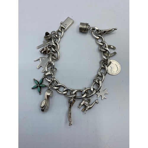 297 - A collection of silver jewellery to include charm bracelet and a white metal identity bracelet, 63g