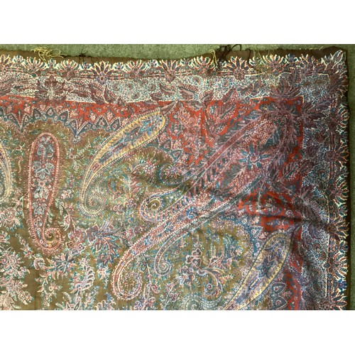 214 - Two Paisley throws/tablecloths both with damage and repairs. Two patterned throws/tablecloths. Embro... 