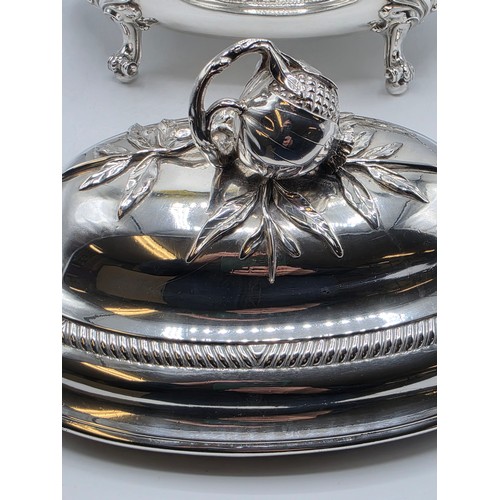 2 - An Irish Silver lidded oval tureen with cast poppy finial,  loop handles on four scroll feet, 38 cm ... 