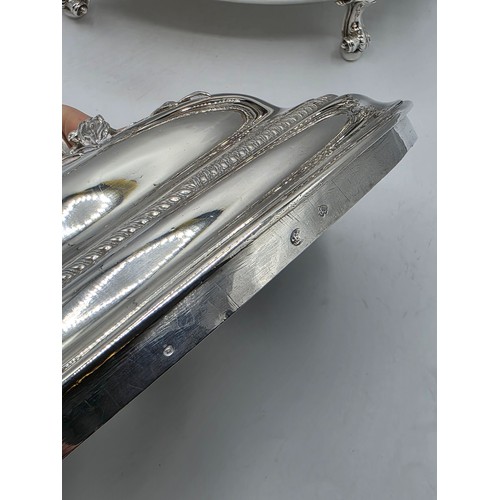 2 - An Irish Silver lidded oval tureen with cast poppy finial,  loop handles on four scroll feet, 38 cm ... 