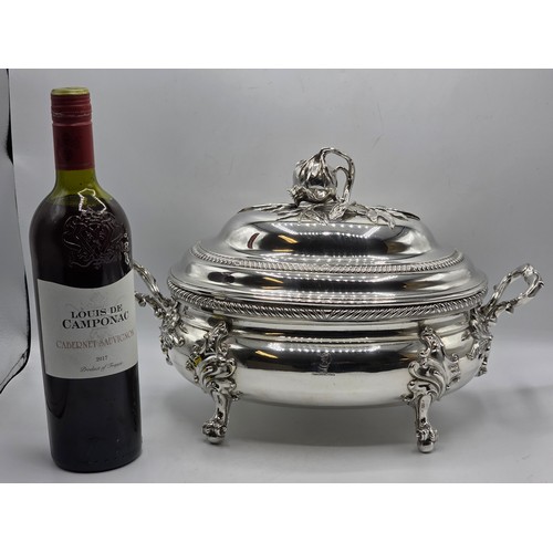 2 - An Irish Silver lidded oval tureen with cast poppy finial,  loop handles on four scroll feet, 38 cm ... 