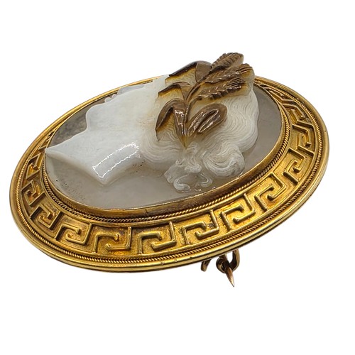 3 - Elena Pistrucci (1822-1886) An unmarked yellow metal hardstone cameo brooch with Greek key oval surr... 