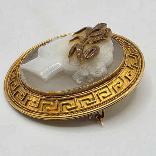 3 - Elena Pistrucci (1822-1886) An unmarked yellow metal hardstone cameo brooch with Greek key oval surr... 