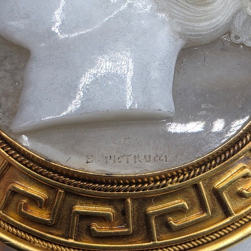 3 - Elena Pistrucci (1822-1886) An unmarked yellow metal hardstone cameo brooch with Greek key oval surr... 
