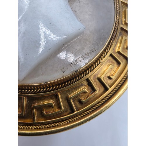 3 - Elena Pistrucci (1822-1886) An unmarked yellow metal hardstone cameo brooch with Greek key oval surr... 