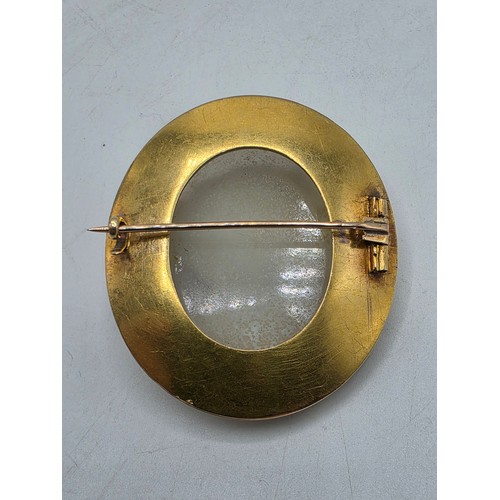3 - Elena Pistrucci (1822-1886) An unmarked yellow metal hardstone cameo brooch with Greek key oval surr... 