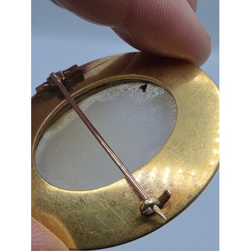 3 - Elena Pistrucci (1822-1886) An unmarked yellow metal hardstone cameo brooch with Greek key oval surr... 