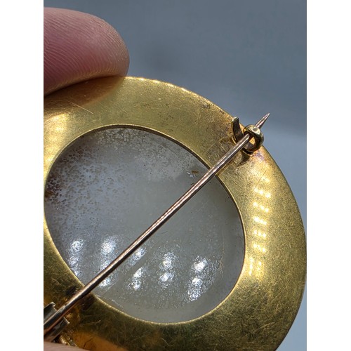 3 - Elena Pistrucci (1822-1886) An unmarked yellow metal hardstone cameo brooch with Greek key oval surr... 