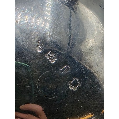 11 - A pair of sterling silver sauceboats with cast beaded rim and scroll handles. With chased armorial o... 