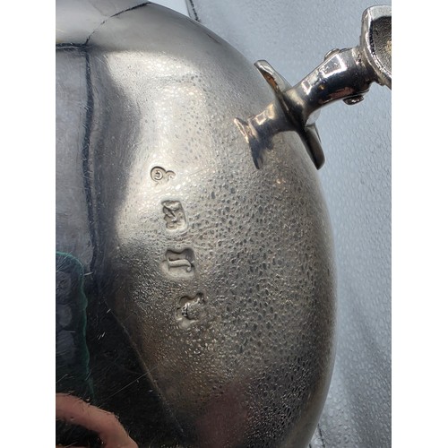 11 - A pair of sterling silver sauceboats with cast beaded rim and scroll handles. With chased armorial o... 