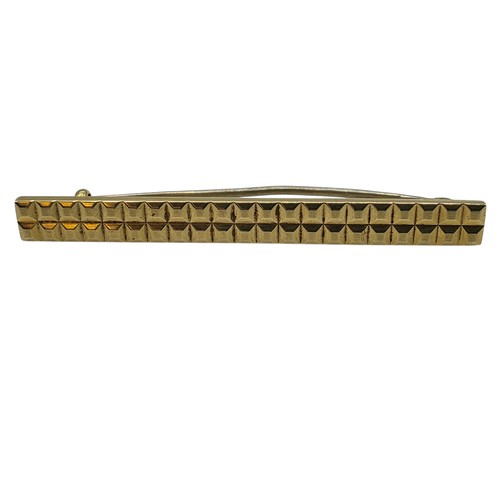 12 - An 18ct gold bar brooch with geometric textured design. 9.9g.