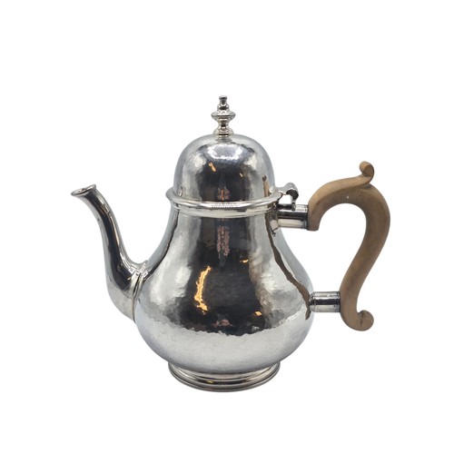 14 - A sterling silver hand planished tea pot, S J Phillips London 2000, gross weight 897 g