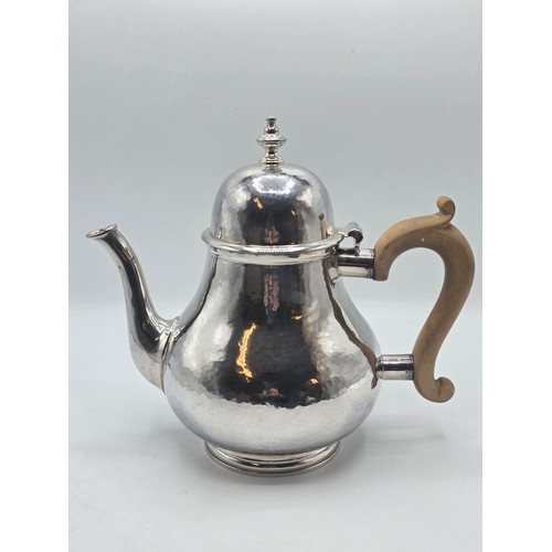 14 - A sterling silver hand planished tea pot, S J Phillips London 2000, gross weight 897 g