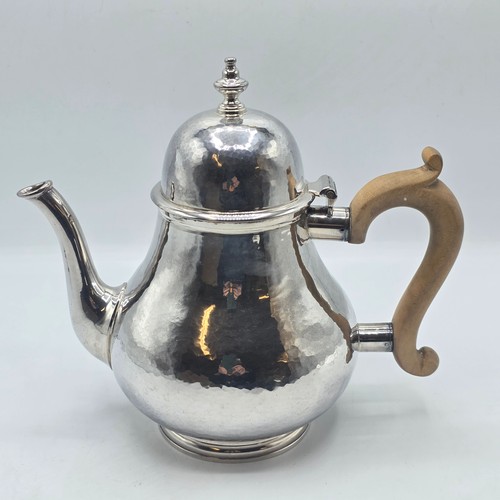 14 - A sterling silver hand planished tea pot, S J Phillips London 2000, gross weight 897 g