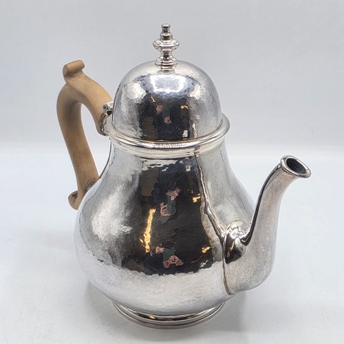 14 - A sterling silver hand planished tea pot, S J Phillips London 2000, gross weight 897 g