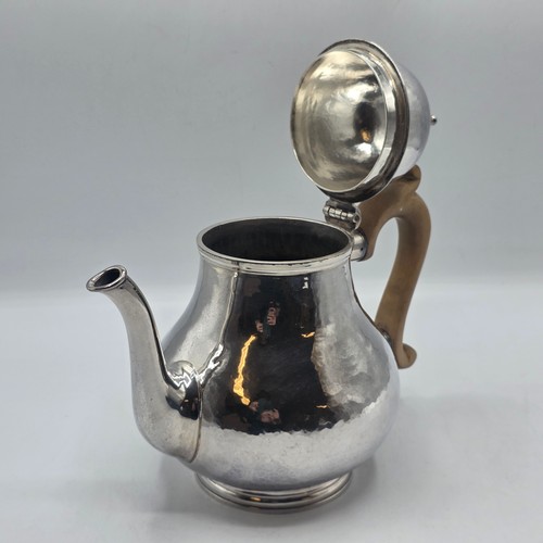 14 - A sterling silver hand planished tea pot, S J Phillips London 2000, gross weight 897 g
