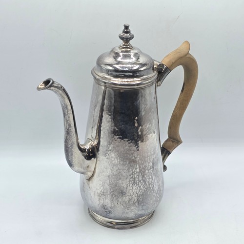 15 - A sterling silver hand planished coffee pot by S J Phillips London 2000, gross weight 911 g
