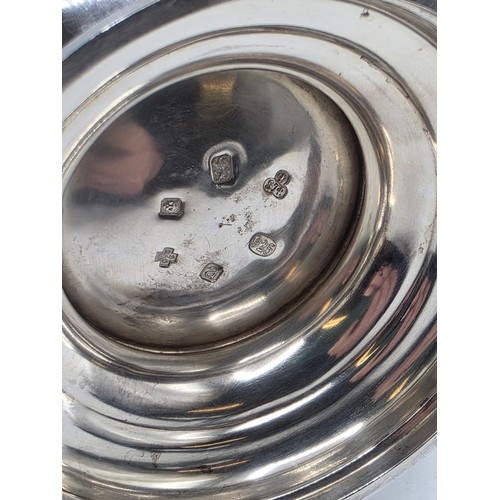 17 - A sterling silver hand planished water jug on circular stepped foot with scroll handle by SJ Phillip... 