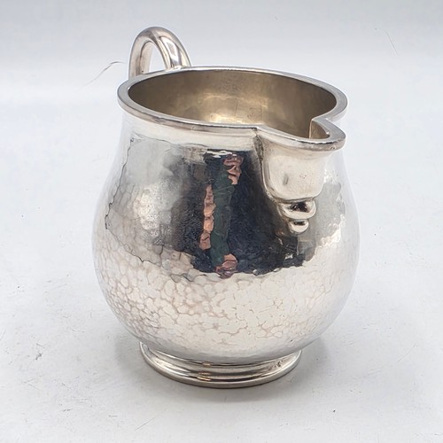 18 - Two matching sterling silver hand planished jugs together with matching hand planished sterling silv... 