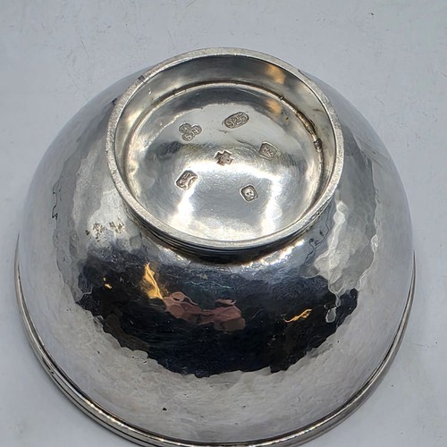 18 - Two matching sterling silver hand planished jugs together with matching hand planished sterling silv... 