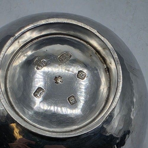 18 - Two matching sterling silver hand planished jugs together with matching hand planished sterling silv... 