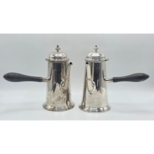 16 - A matched pair of sterling silver chocolate pots with ebonised handles, Martin Hall & Co.  Sheffield... 