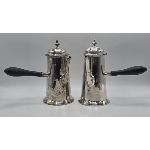 16 - A matched pair of sterling silver chocolate pots with ebonised handles, Martin Hall & Co.  Sheffield... 