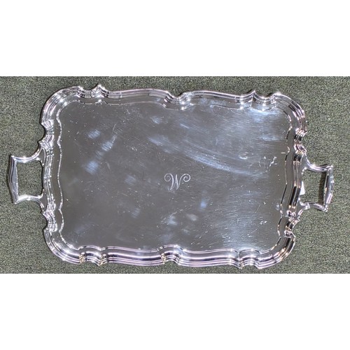 6 - A sterling silver oblong tray with cast handles 64 cm x 37 cm.  Barker Brothers Ltd Chester 1911.  2... 