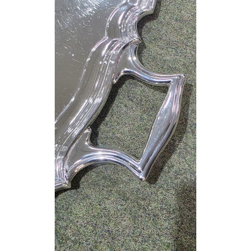 6 - A sterling silver oblong tray with cast handles 64 cm x 37 cm.  Barker Brothers Ltd Chester 1911.  2... 