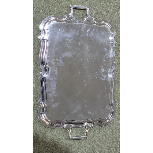 6 - A sterling silver oblong tray with cast handles 64 cm x 37 cm.  Barker Brothers Ltd Chester 1911.  2... 