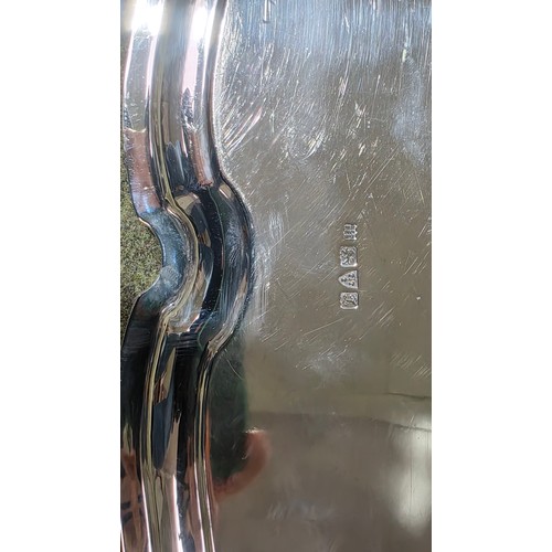 6 - A sterling silver oblong tray with cast handles 64 cm x 37 cm.  Barker Brothers Ltd Chester 1911.  2... 
