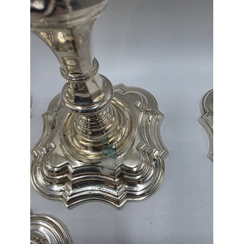 9 - A set of eight solid sterling silver table candlesticks, stepped square basis, S J Phillips London L... 