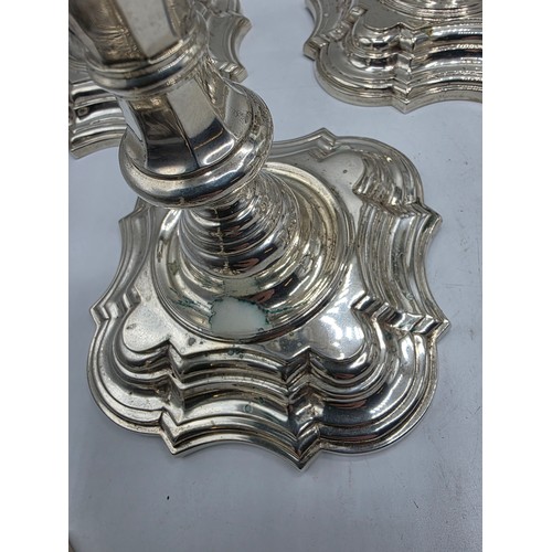 9 - A set of eight solid sterling silver table candlesticks, stepped square basis, S J Phillips London L... 