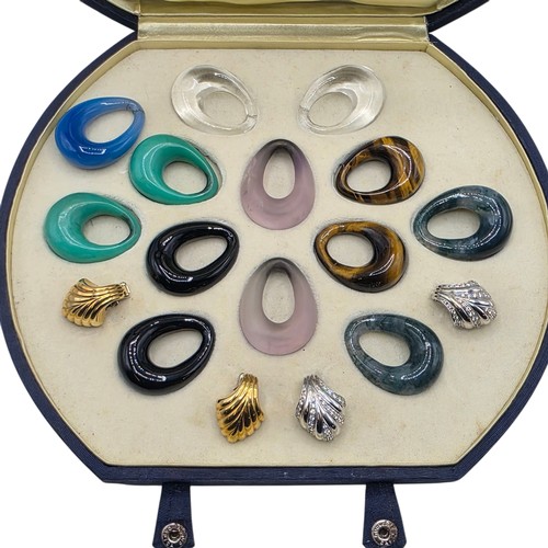 26 - An unmarked yellow and white metal diamond set metamorphic earing set in fitted felt lined case with... 