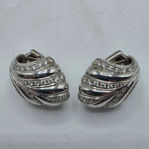 26 - An unmarked yellow and white metal diamond set metamorphic earing set in fitted felt lined case with... 