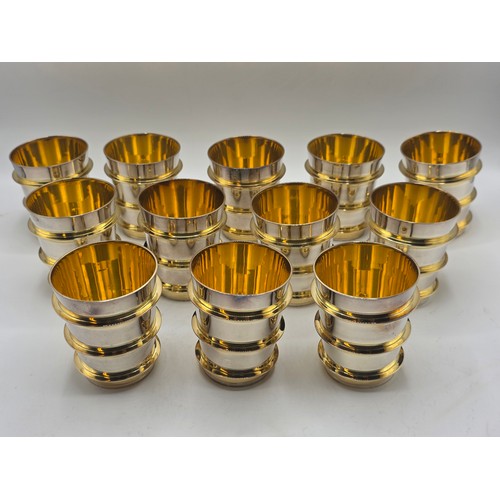 27 - A set of twelve  Sterling silver gilt water beakers with gilt ribbed design and interiors each 9.5 c... 