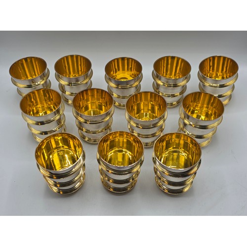 27 - A set of twelve  Sterling silver gilt water beakers with gilt ribbed design and interiors each 9.5 c... 