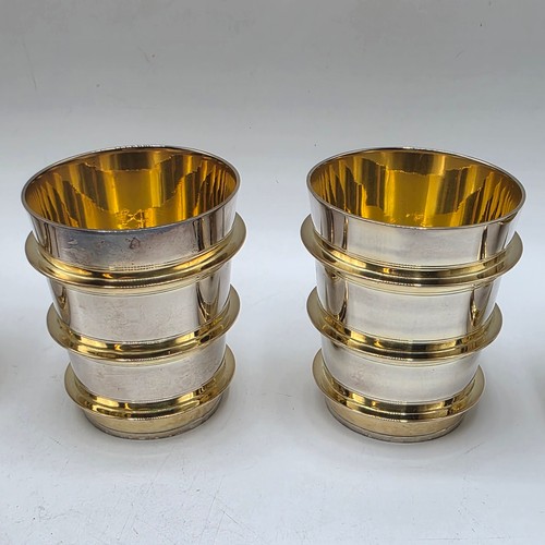 27 - A set of twelve  Sterling silver gilt water beakers with gilt ribbed design and interiors each 9.5 c... 