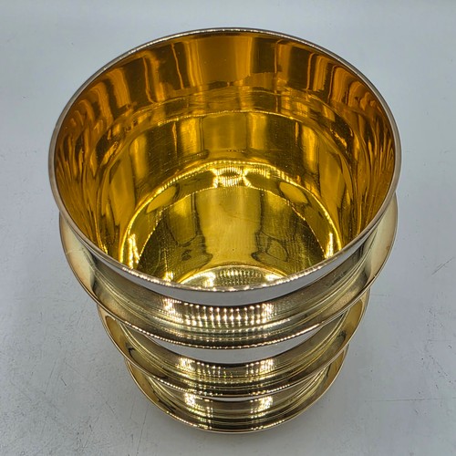 27 - A set of twelve  Sterling silver gilt water beakers with gilt ribbed design and interiors each 9.5 c... 