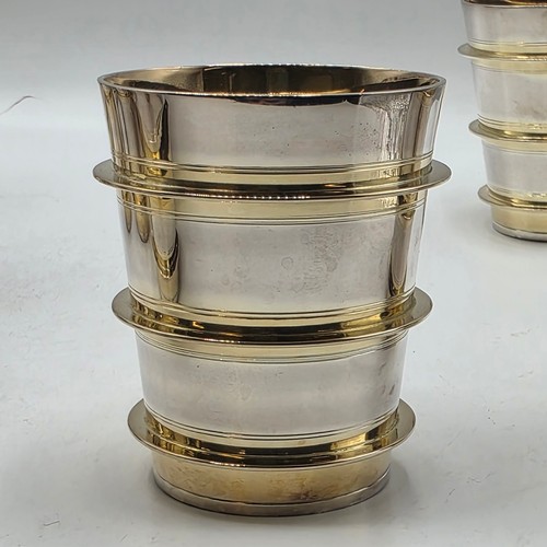 27 - A set of twelve  Sterling silver gilt water beakers with gilt ribbed design and interiors each 9.5 c... 