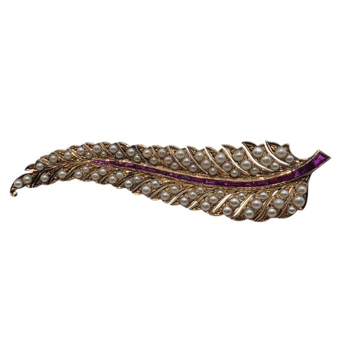 25 - An unmarked yellow metal pearl and ruby Fern Brooch set with graduated line of channel set rubies an... 